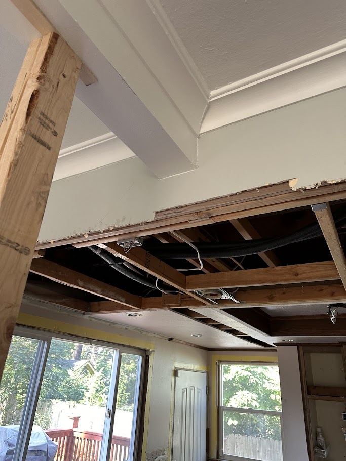 Beam installation — ceiling opened, header going in