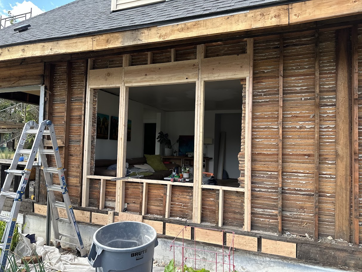 Exterior view of wall opening with exposed framing during remodel in Spokane