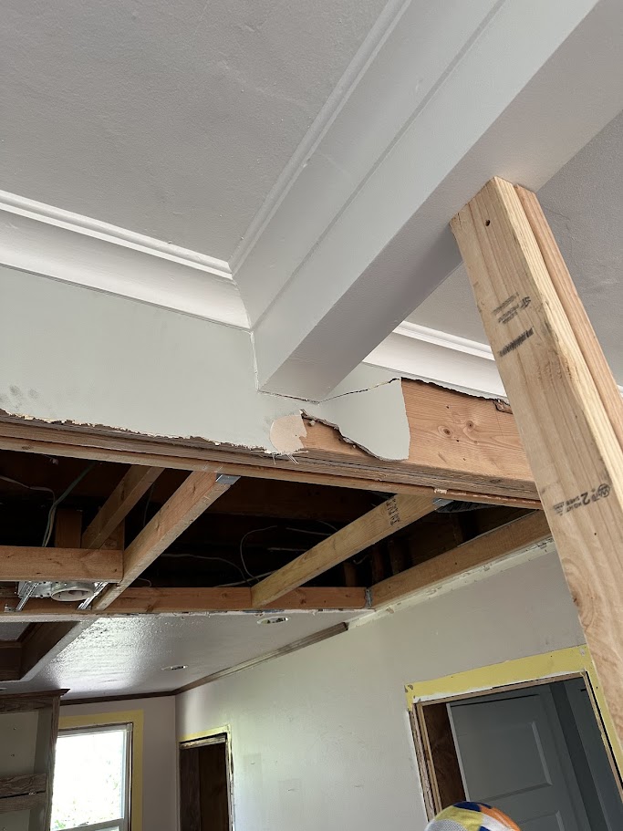 Structural beam detail at ceiling junction showing new lumber and framing